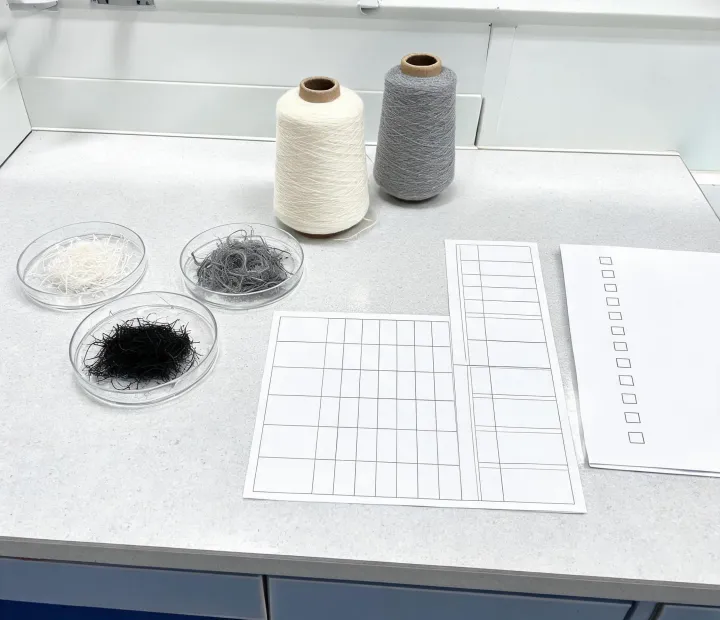 Fiber and yarn evidence documents beside test samples